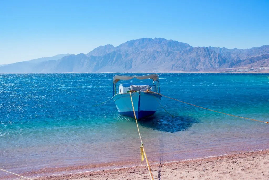 Blue Lagoon with boat in Dahab Sinai Kite Lagoon of Dahab Egypt