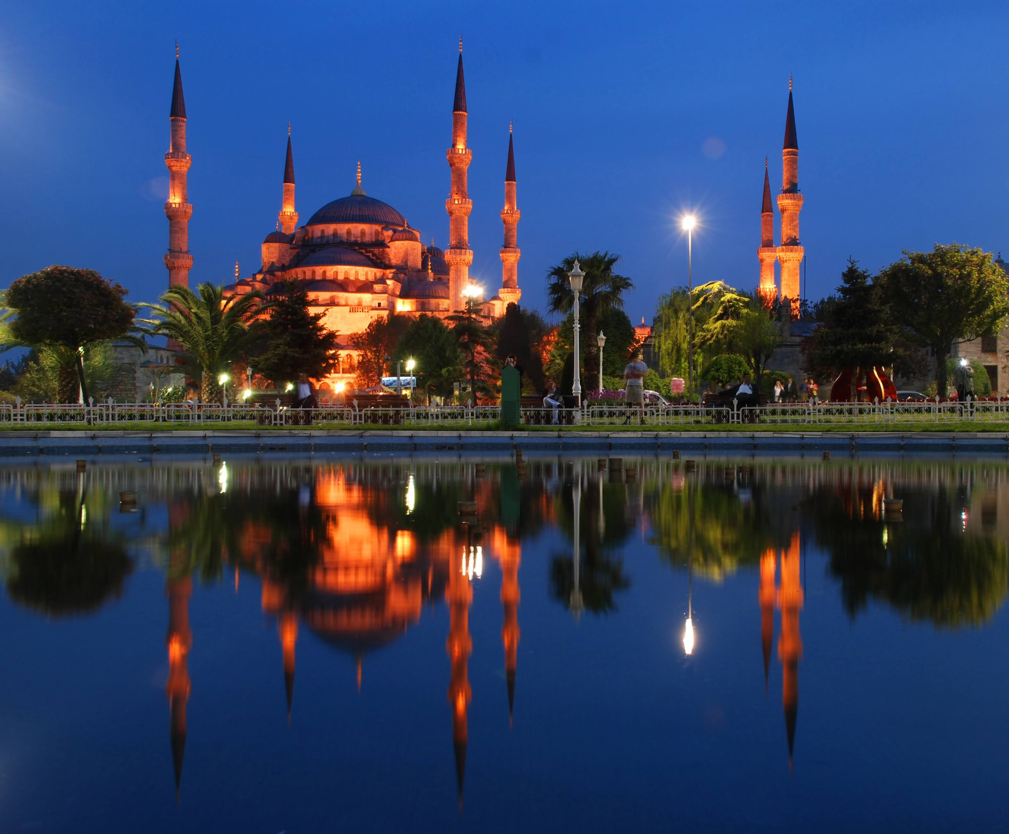 The Blue Mosque with its distinctive six minarets and domes reflected in water at twilight