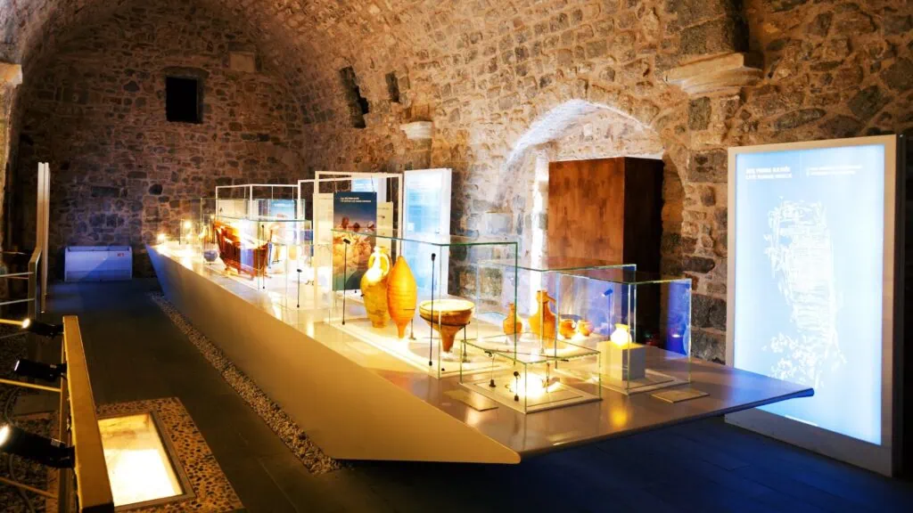 Bodrum Underwater Archaeology Museum interior with stone walls and glass display cases showcasing ancient amphorae Bodrum