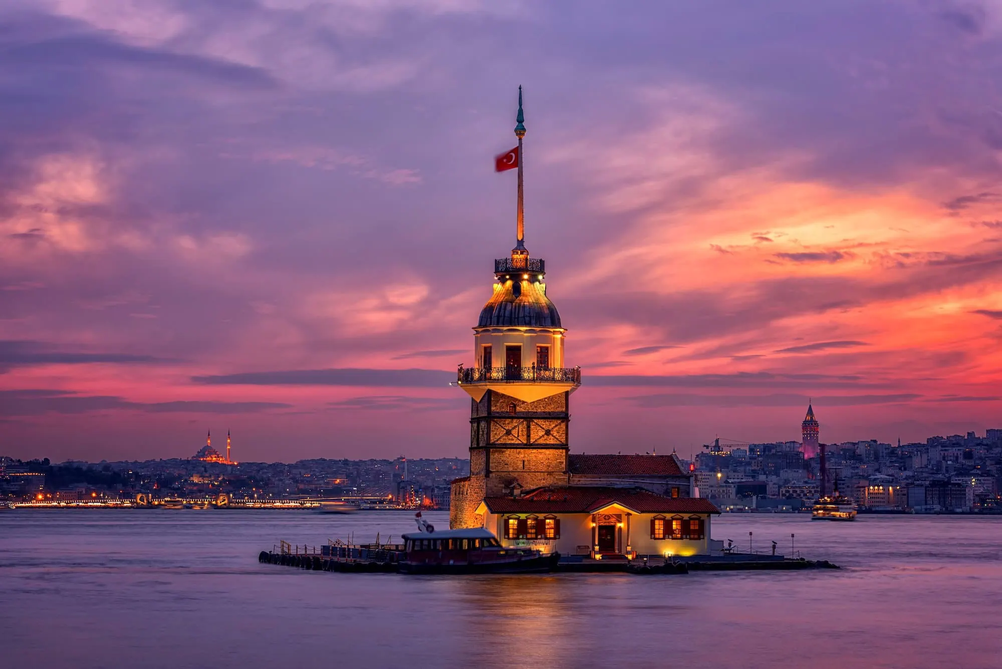 Maiden's Tower illuminated at sunset on the Bosphorus Strait in Istanbul