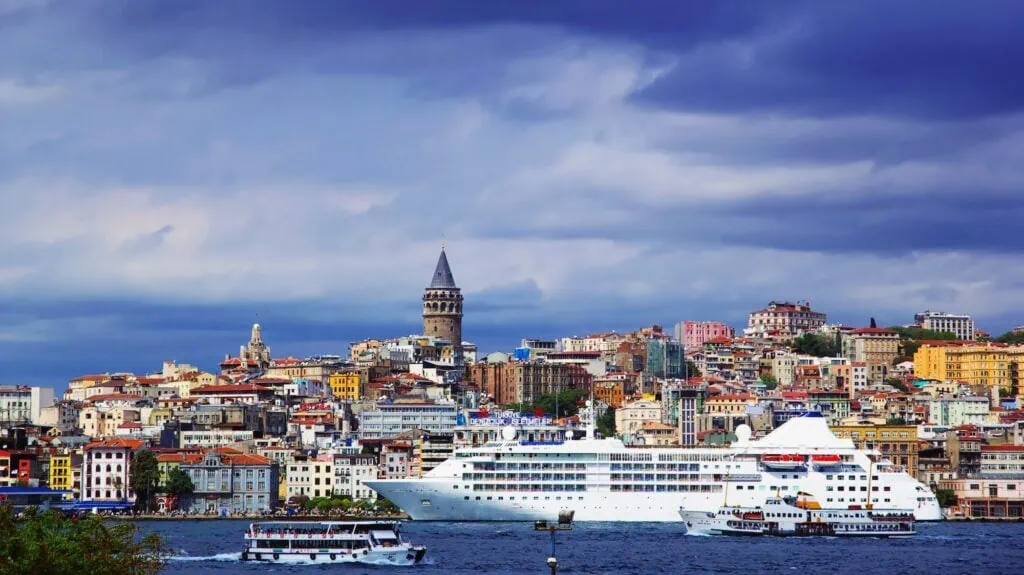 Bosphorus waterfront with boats and Galata Tower rising above city buildings Istanbul