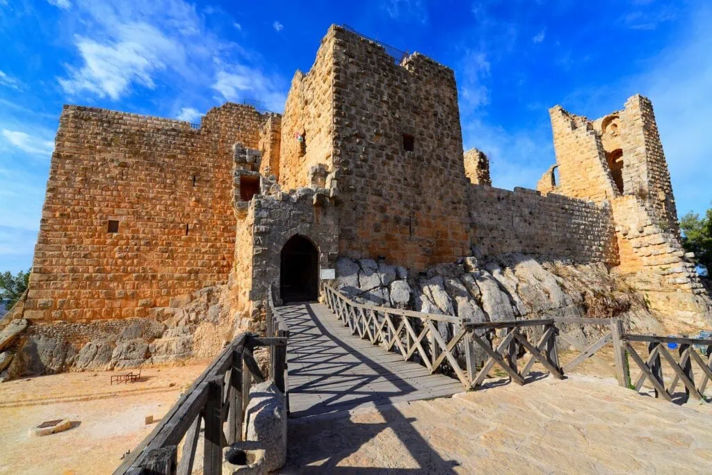 Stone walls, towers, and fortified structures of Ajloun Castle positioned on a mountain ridge, Ajloun