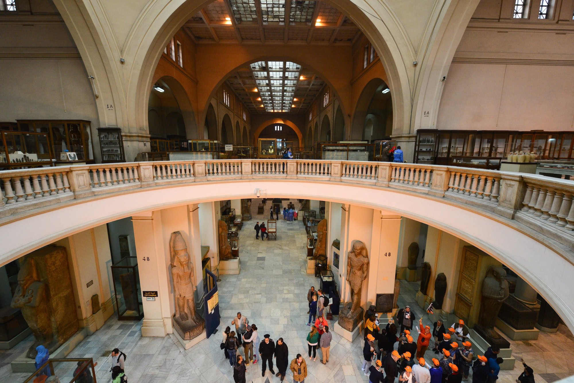 Interior of Egyptian Museum in Cairo showing tourists exploring ancient Egyptian artifacts in grand hall