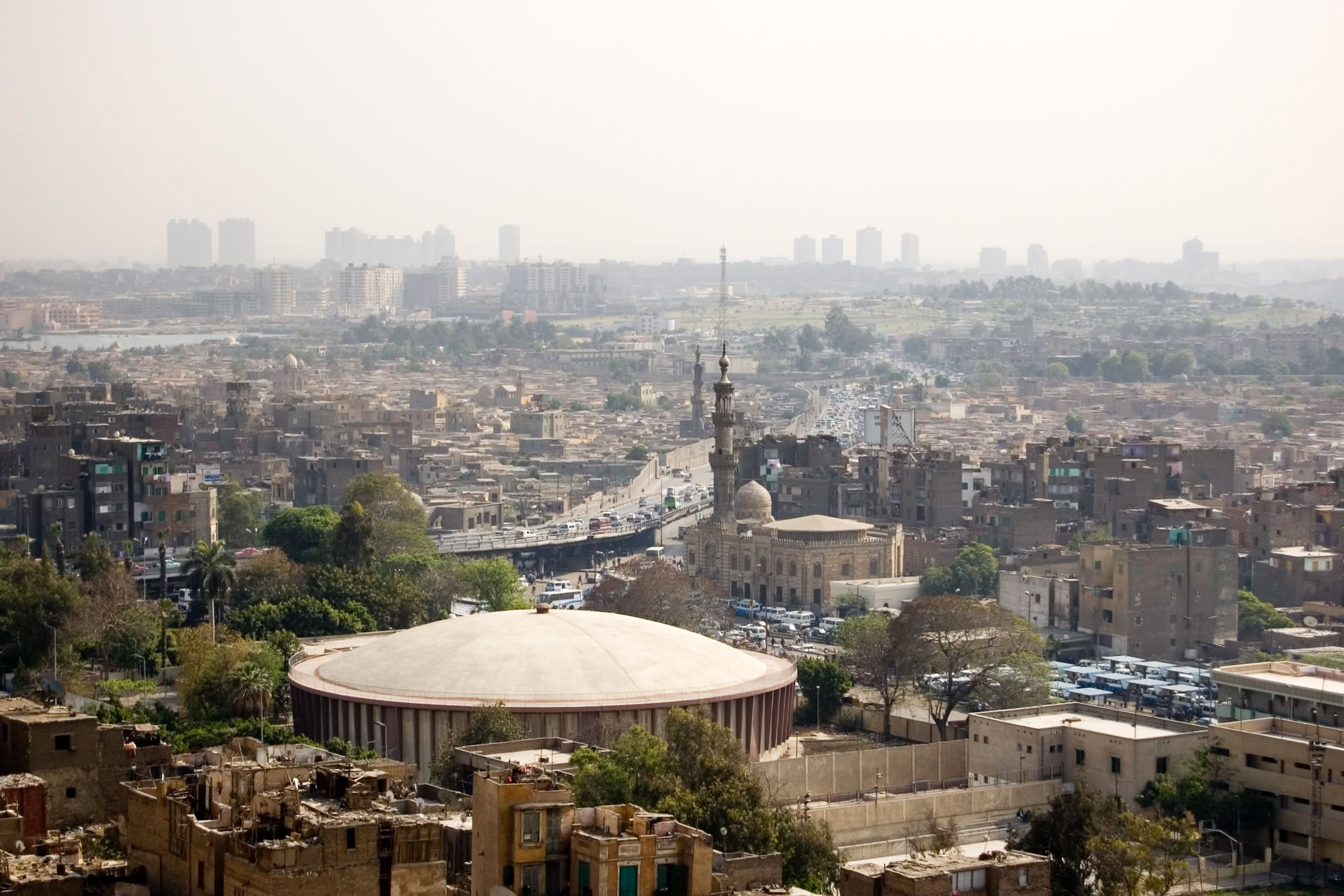 Cairo cityscape featuring Islamic architecture with domed mosque and minaret