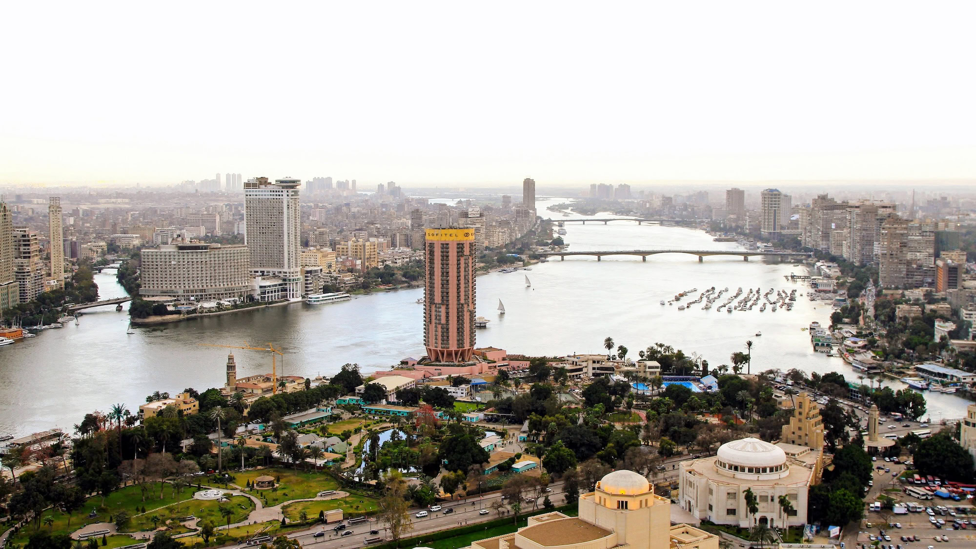 Aerial view of Cairo cityscape with Nile River, bridges, and high-rise buildings