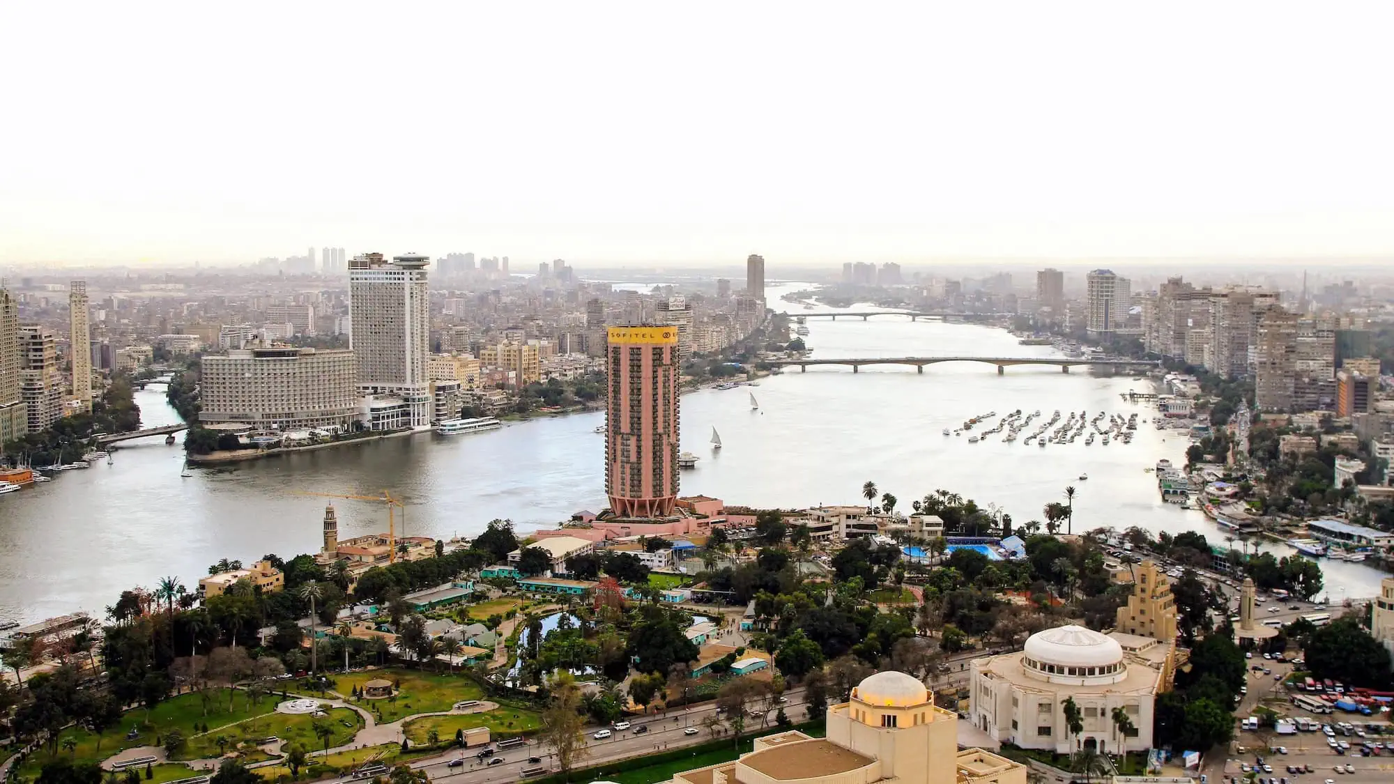 Aerial view of Cairo cityscape with Nile River, bridges, and high-rise buildings