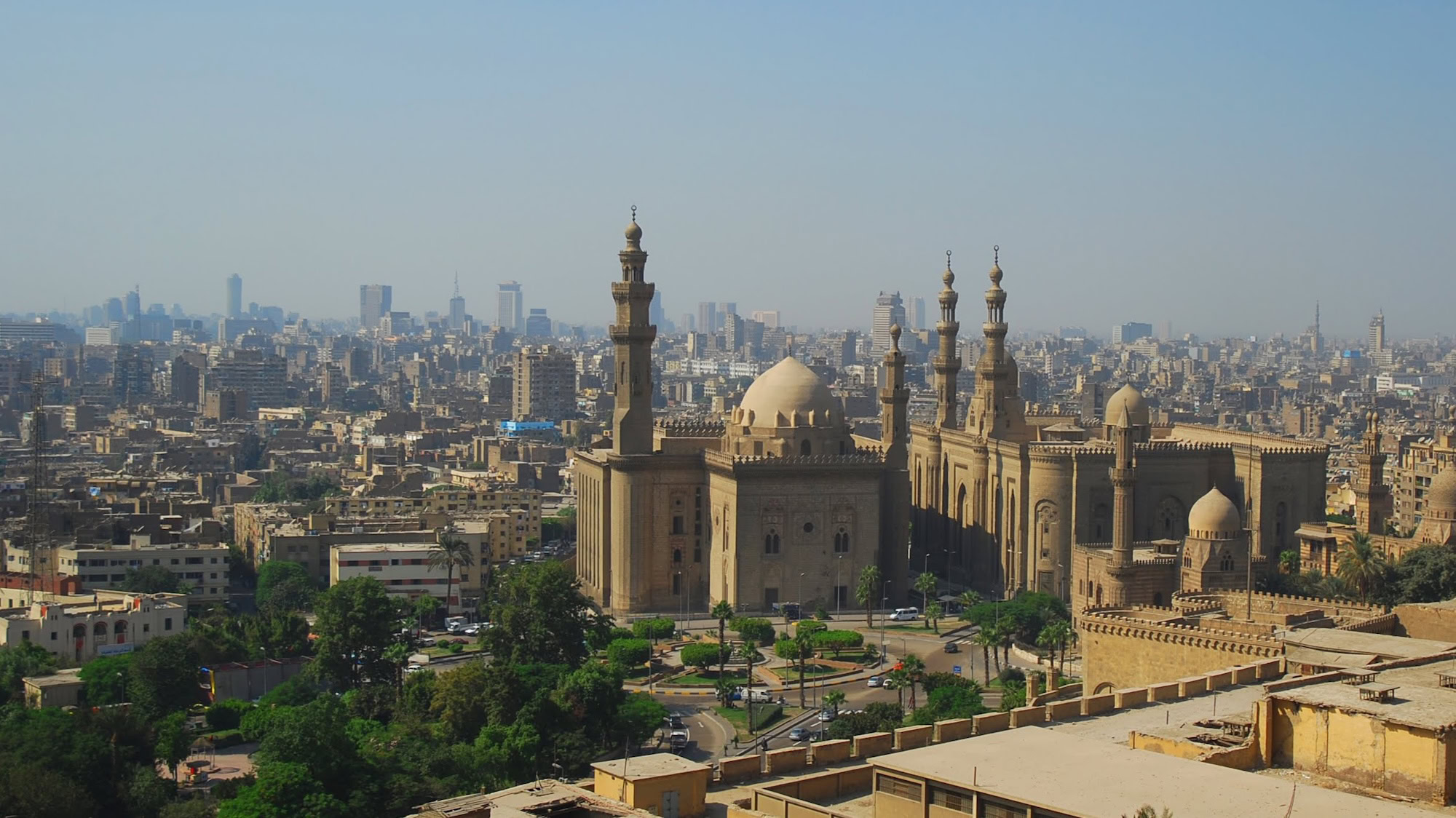Sultan Hassan Mosque with minarets and dome in Cairo cityscape