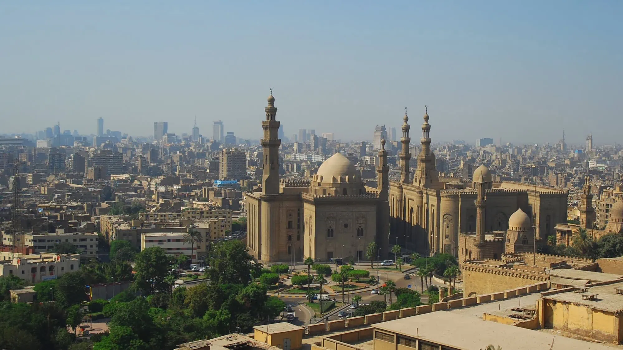 Sultan Hassan Mosque with minarets and dome in Cairo cityscape