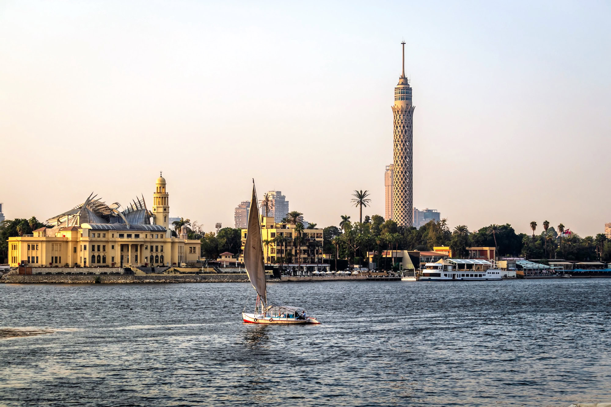 Traditional felucca sailboat on the Nile River in Cairo with Cairo Tower in background