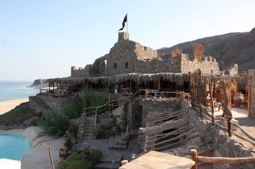 Stone-built towers and terraces of Castle Zaman overlooking the desert landscape in Taba
