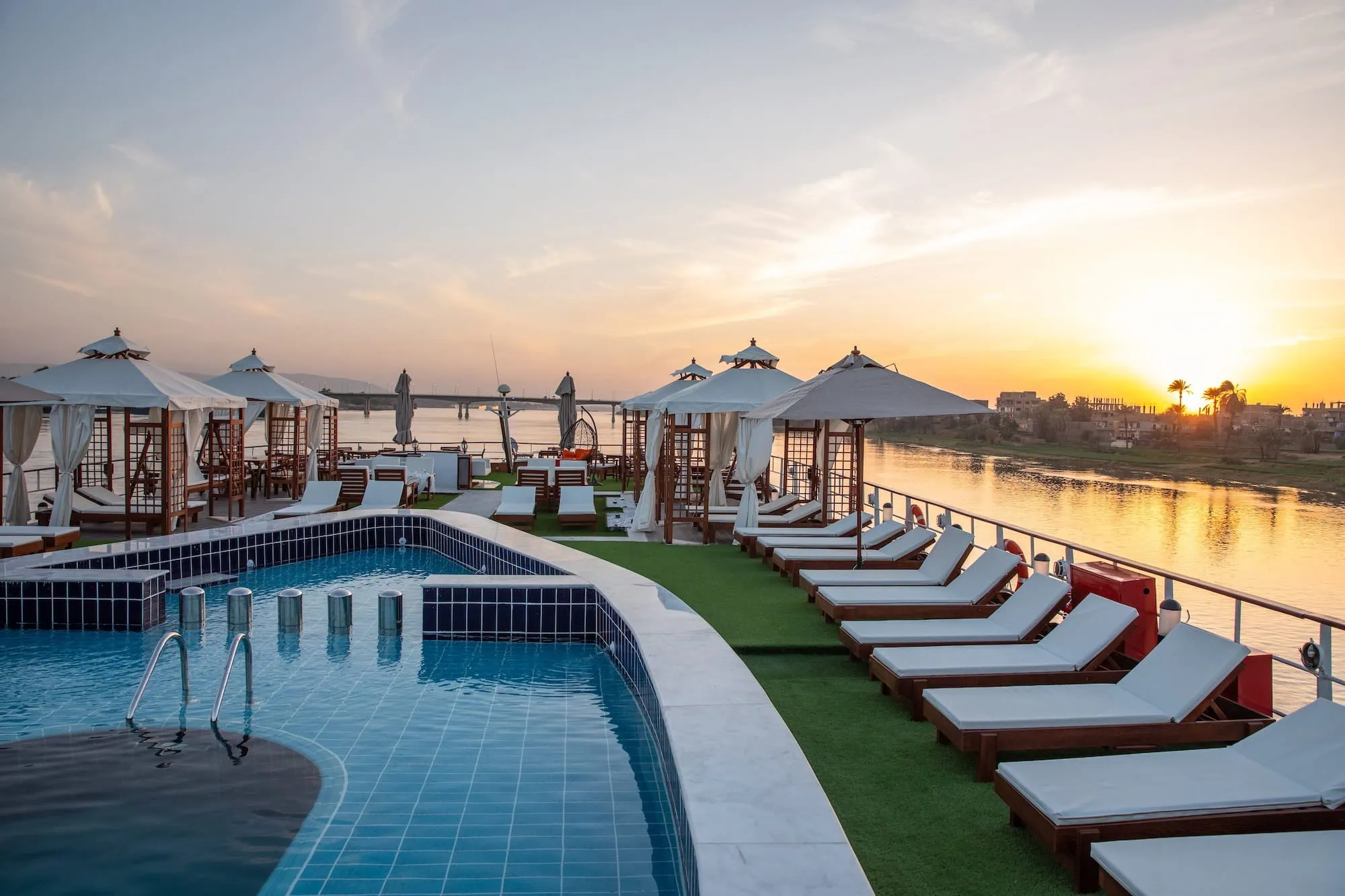 Luxury Nile cruise ship deck with swimming pool and sun loungers