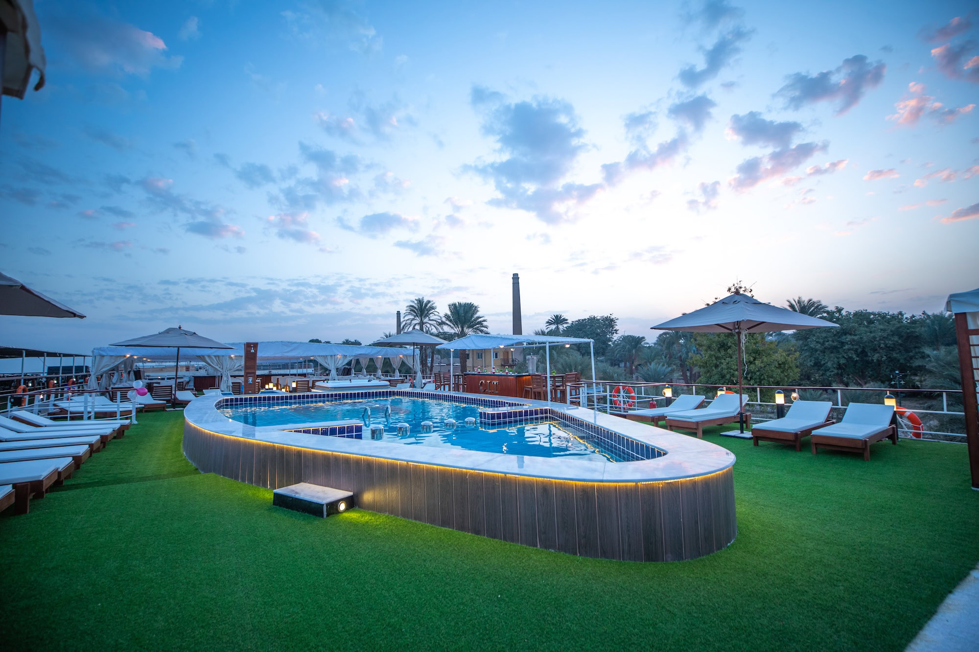 Luxury Nile cruise ship deck with pool, lounge chairs, and amenities for comfortable Egyptian travel