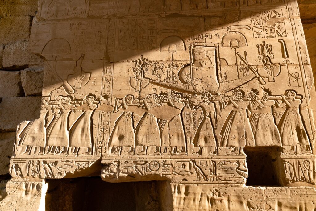 Close-up view of carved hieroglyphic relief details on stone walls at the Ramesseum, Luxor