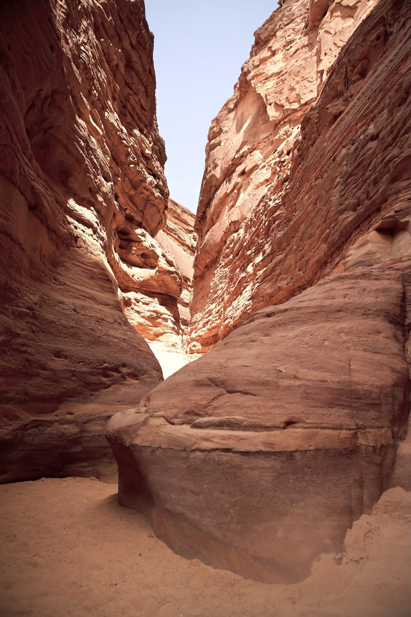 Narrow canyon with towering red and orange sandstone walls in Egypt's Colored Canyon