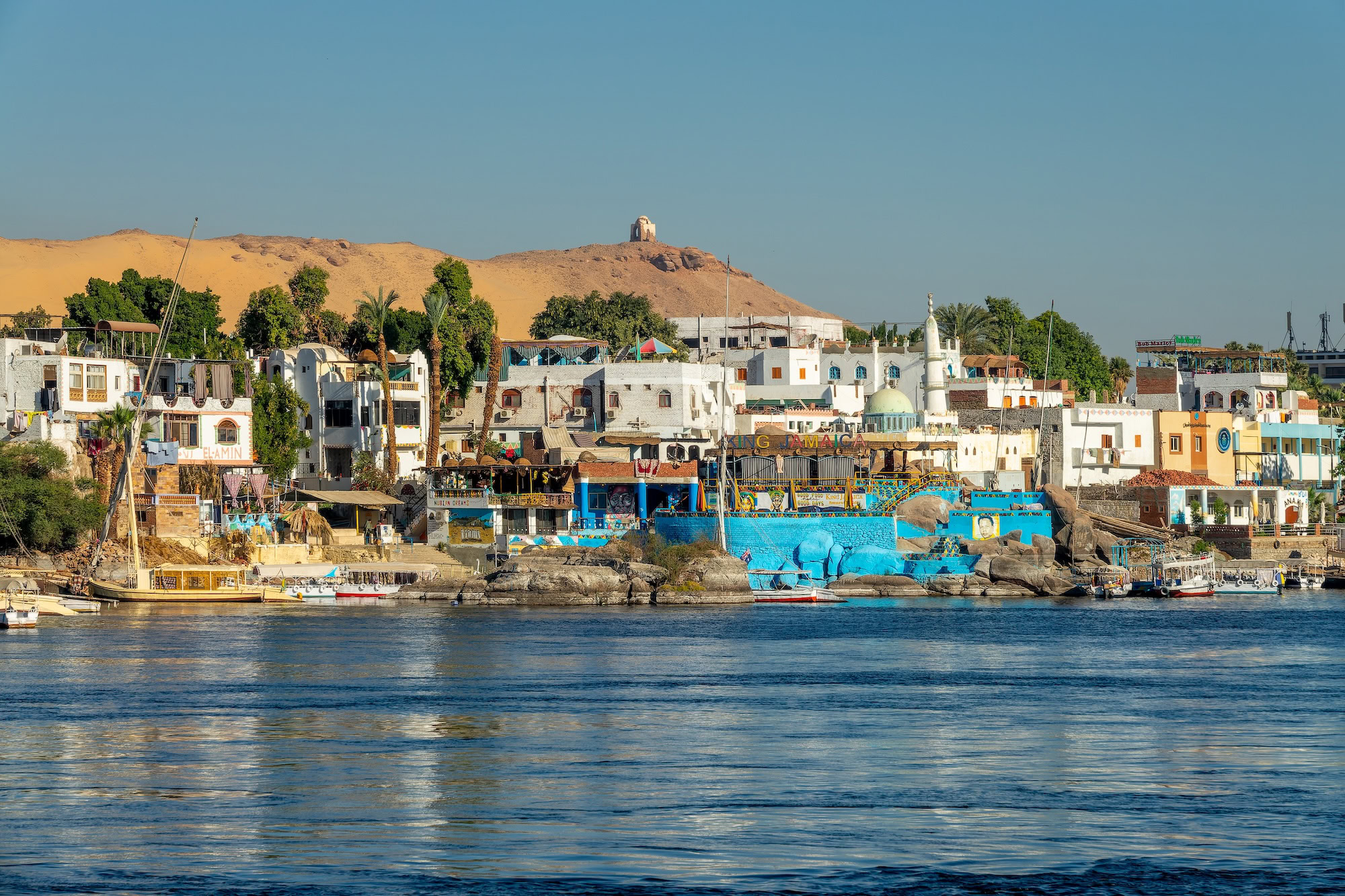 Traditional Nubian village with colorful houses along the Nile River in Aswan