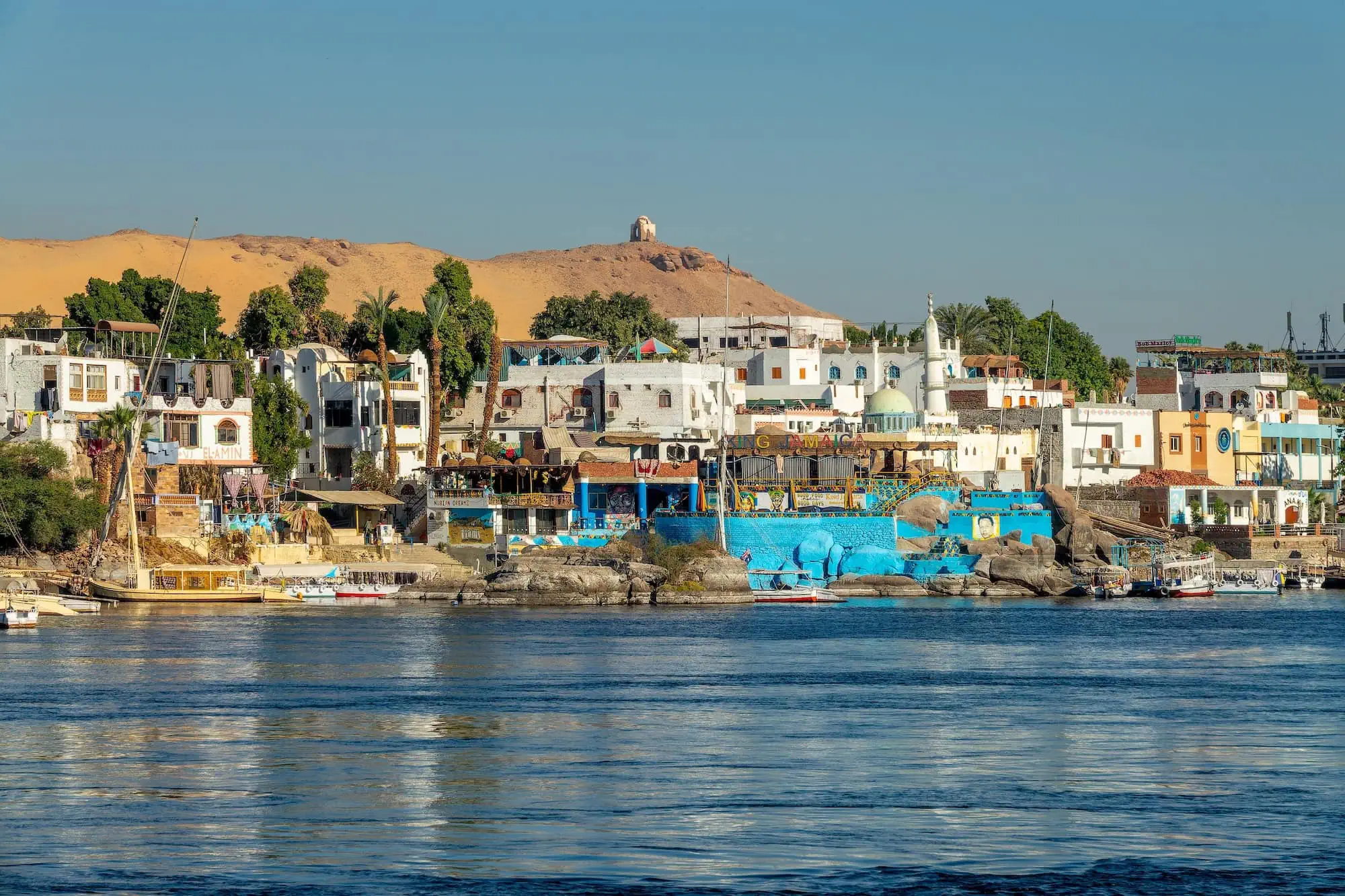 Colorful traditional Nubian houses along the Nile River on Elephantine Island in Aswan