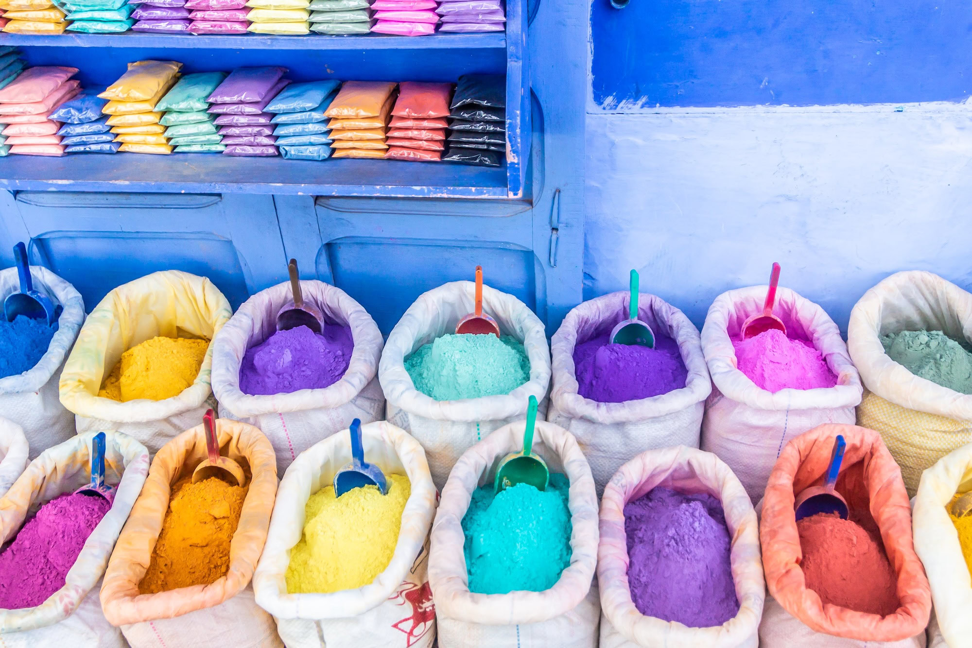 Colorful spices and powders displayed at a traditional Moroccan market stall