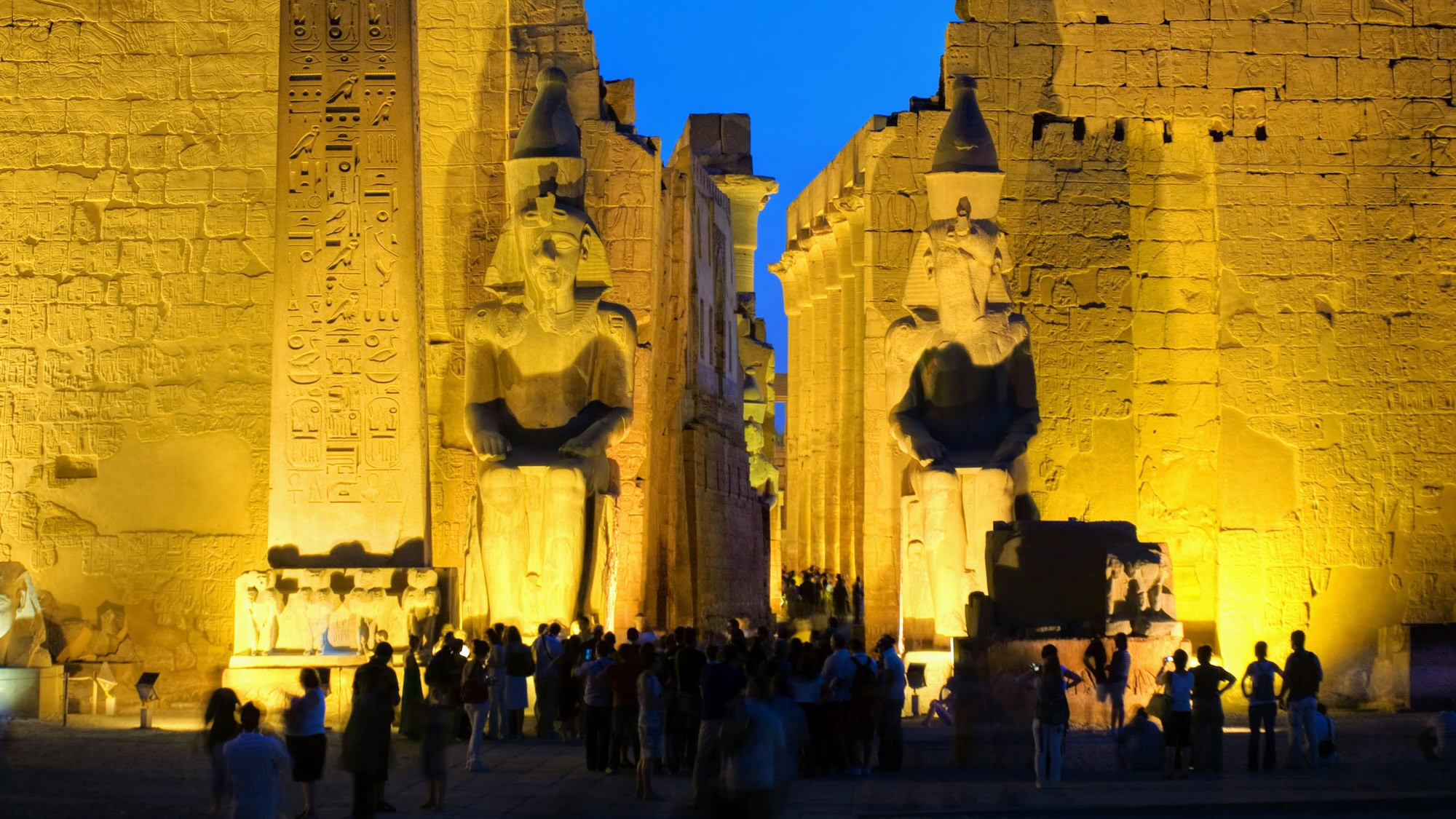 Imposing pharaoh statues and hieroglyphic carvings at Luxor Temple