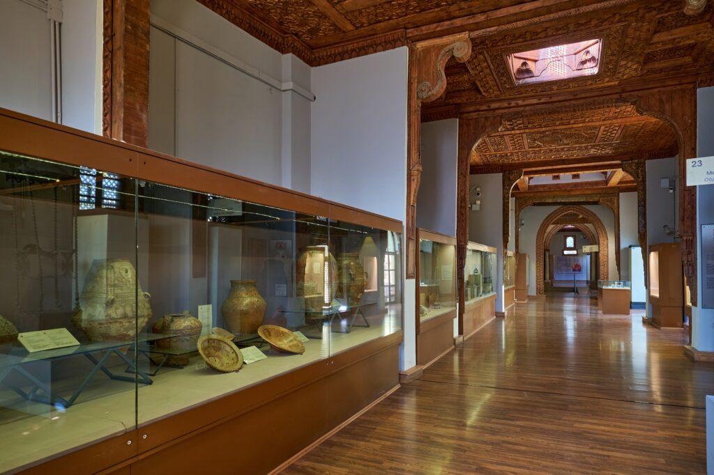 Interior display cases showing Coptic artifacts, manuscripts, and decorative objects inside the Coptic Museum, Cairo