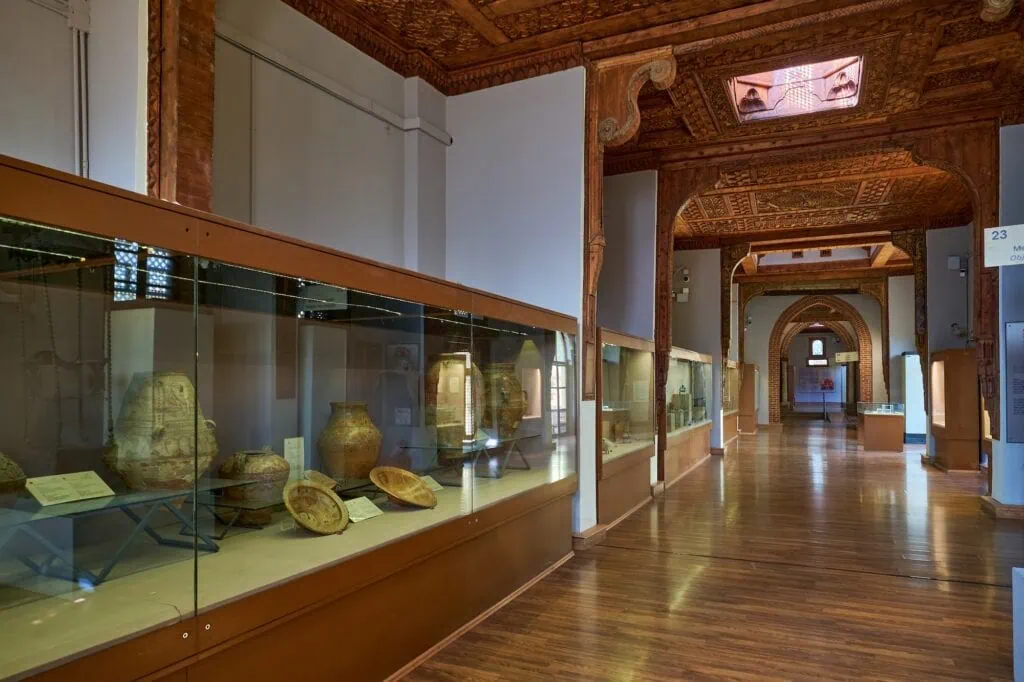 Interior display cases showing Coptic artifacts, manuscripts, and decorative objects inside the Coptic Museum, Cairo