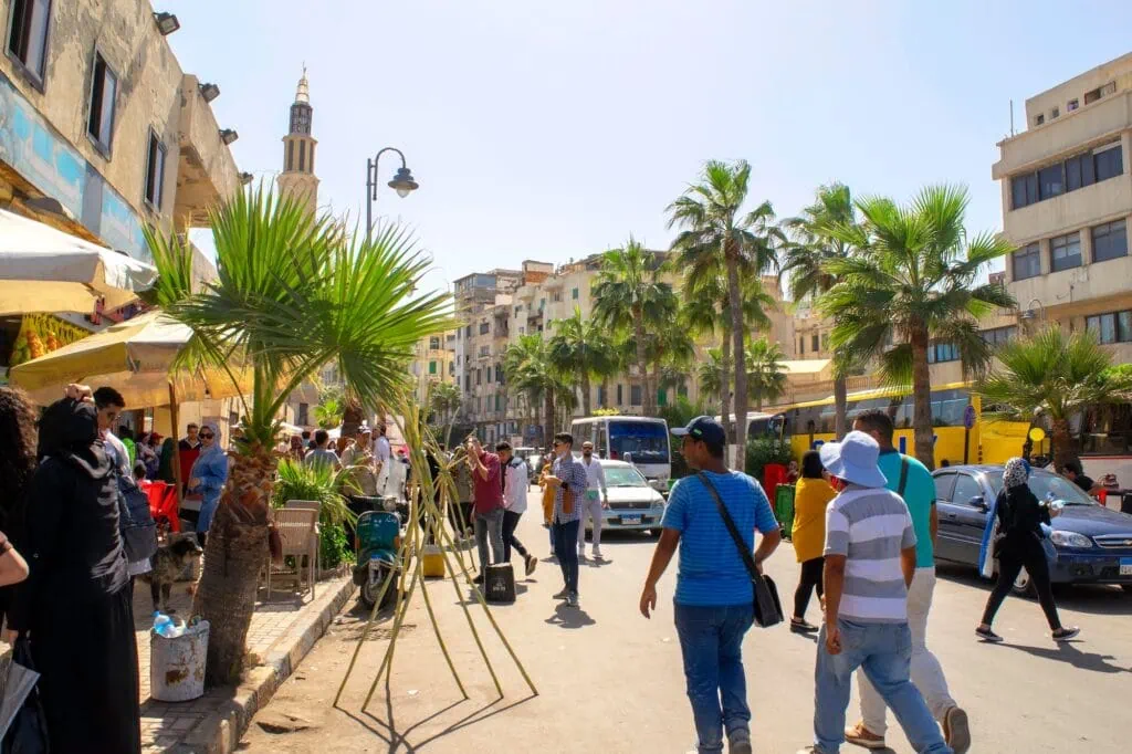 Corniche Street with pedestrian activity and visitors during a feast period, Alexandria