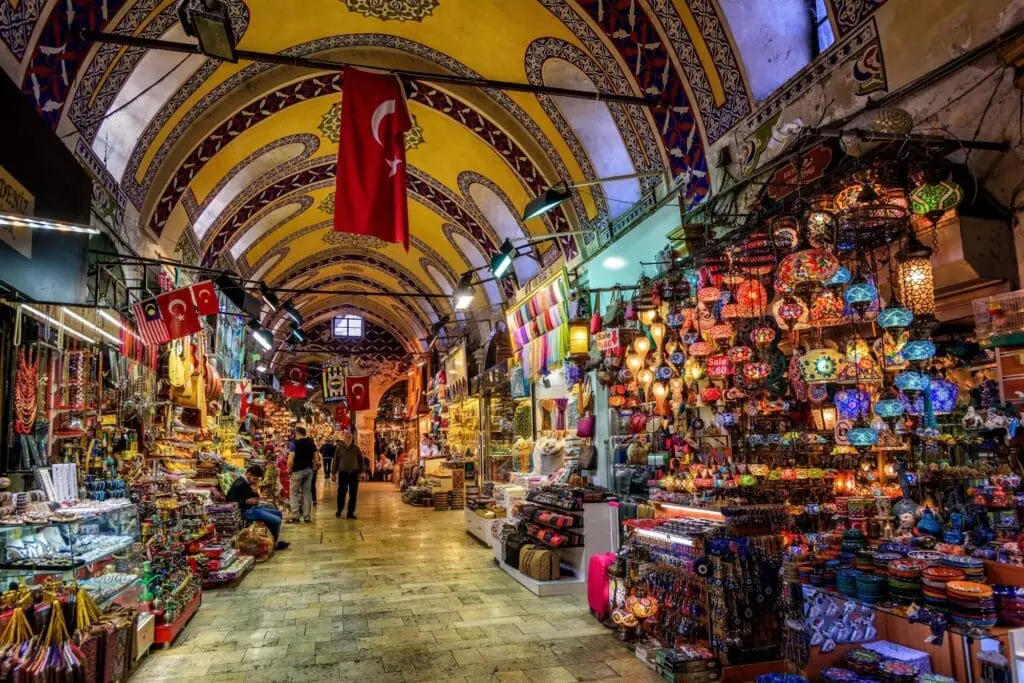 Interior of the Grand Bazaar in Istanbul – also known as the Covered Bazaar – with vaulted ceilings, colorful shops, and vibrant stalls selling Turkish goods.