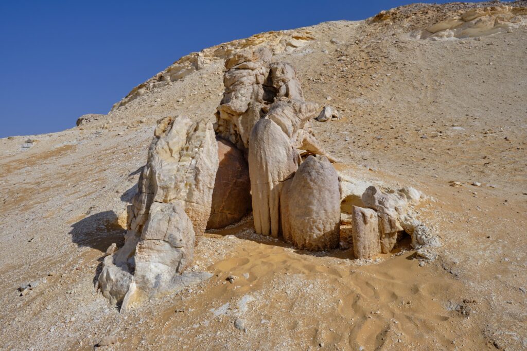 Translucent crystal formations rising from desert limestone outcrops at Crystal Mountain Protected Area, Farafra Oasis