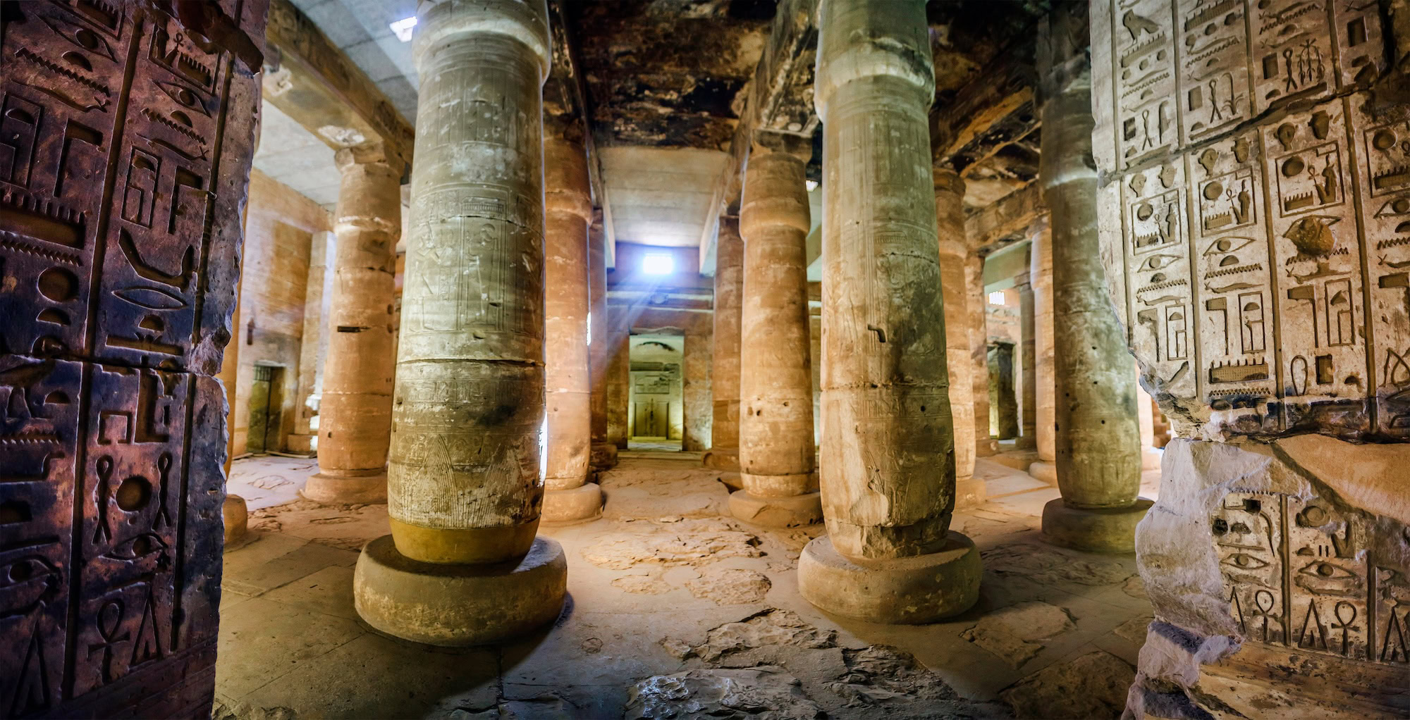 Interior de templo egipcio antiguo con jeroglíficos tallados en las columnas