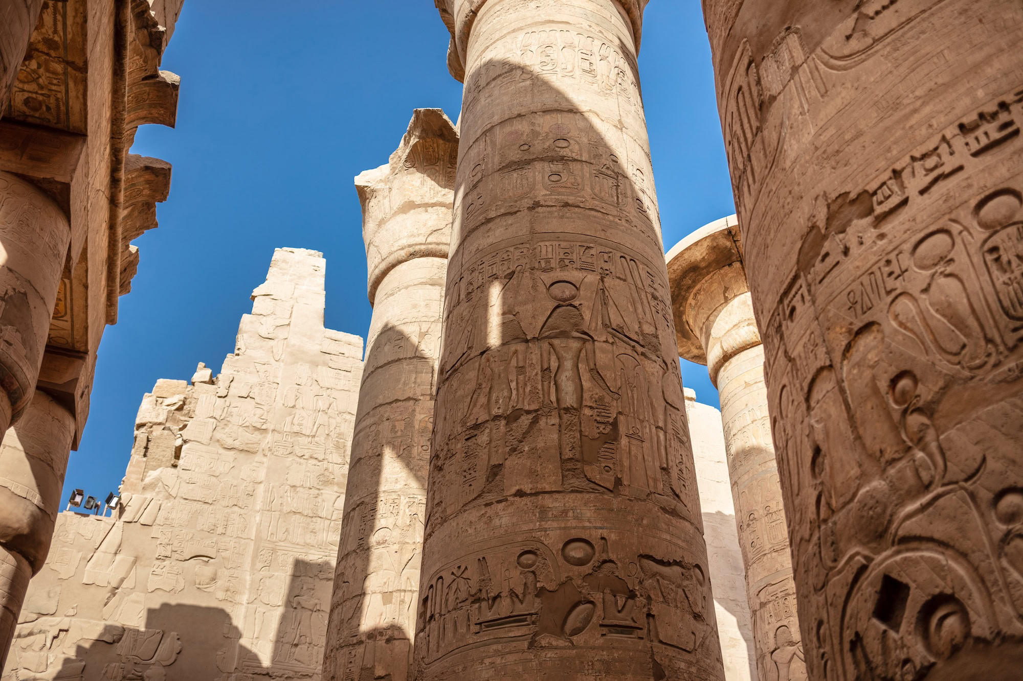 Massive ancient Egyptian stone columns with hieroglyphic carvings at Karnak Temple