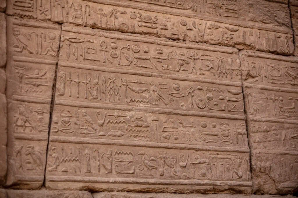 Ancient hieroglyphs carved into the walls of Karnak Temple