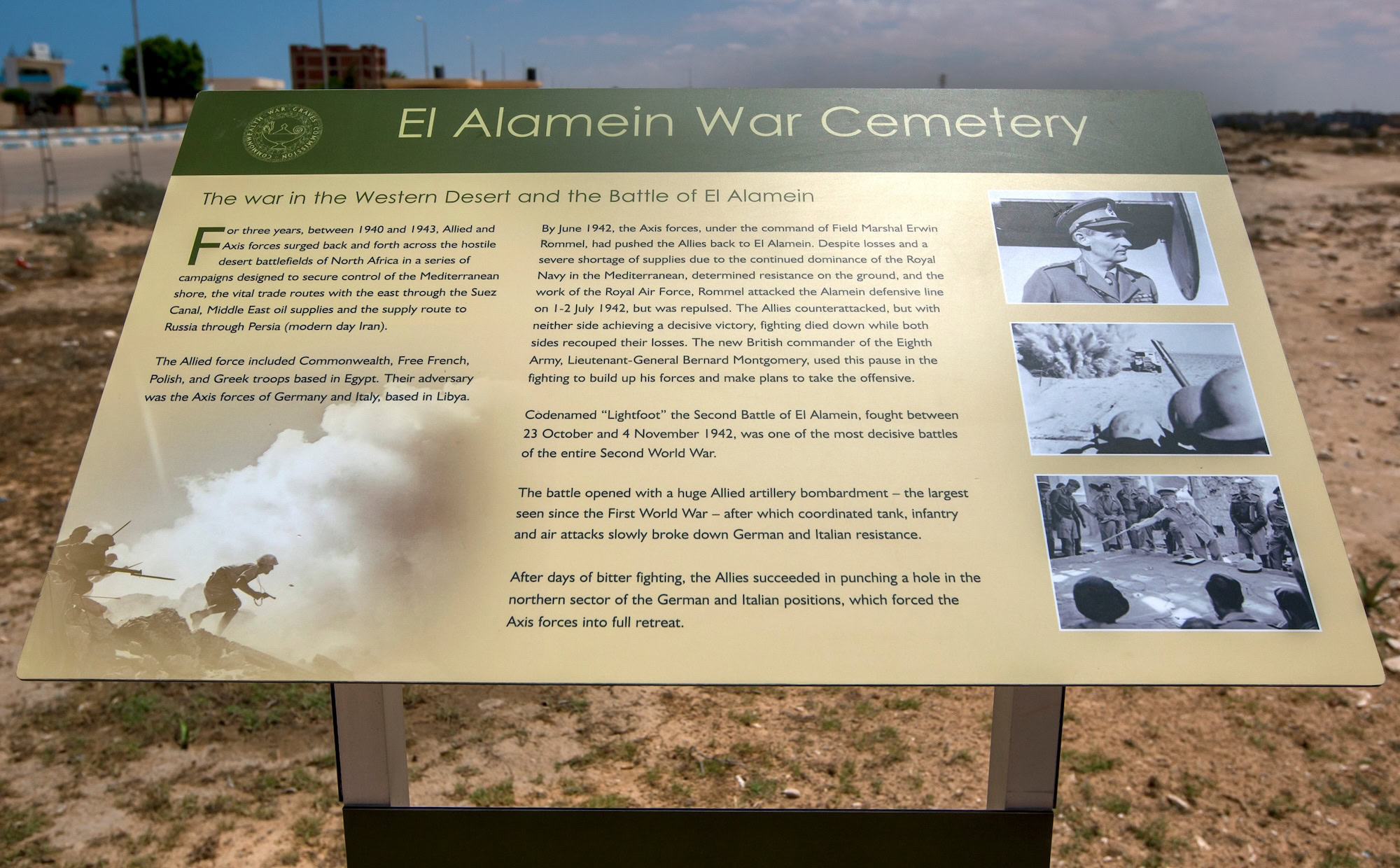 El Alamein War Cemetery memorial site with informational plaque and war photographs in desert landscape