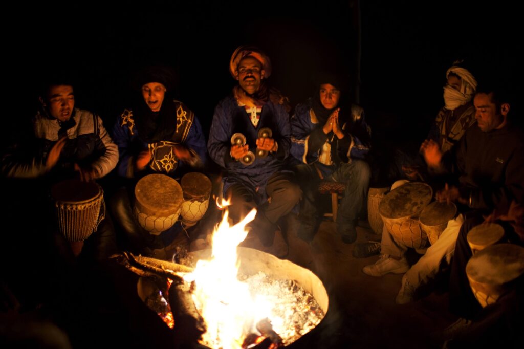 Bedouin musicians playing traditional music at a desert campsite