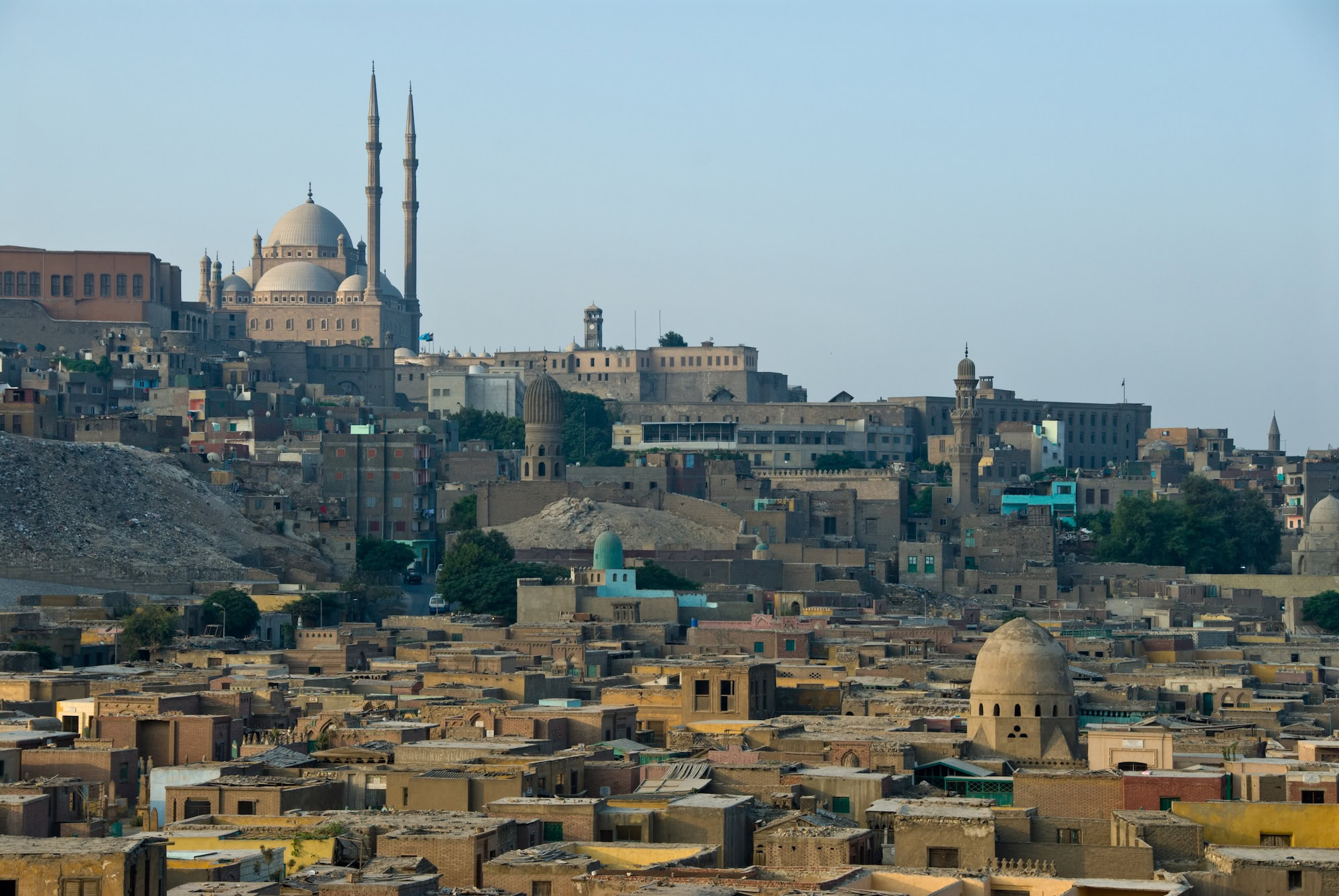 Dense residential buildings in Cairo with Islamic mosque in background