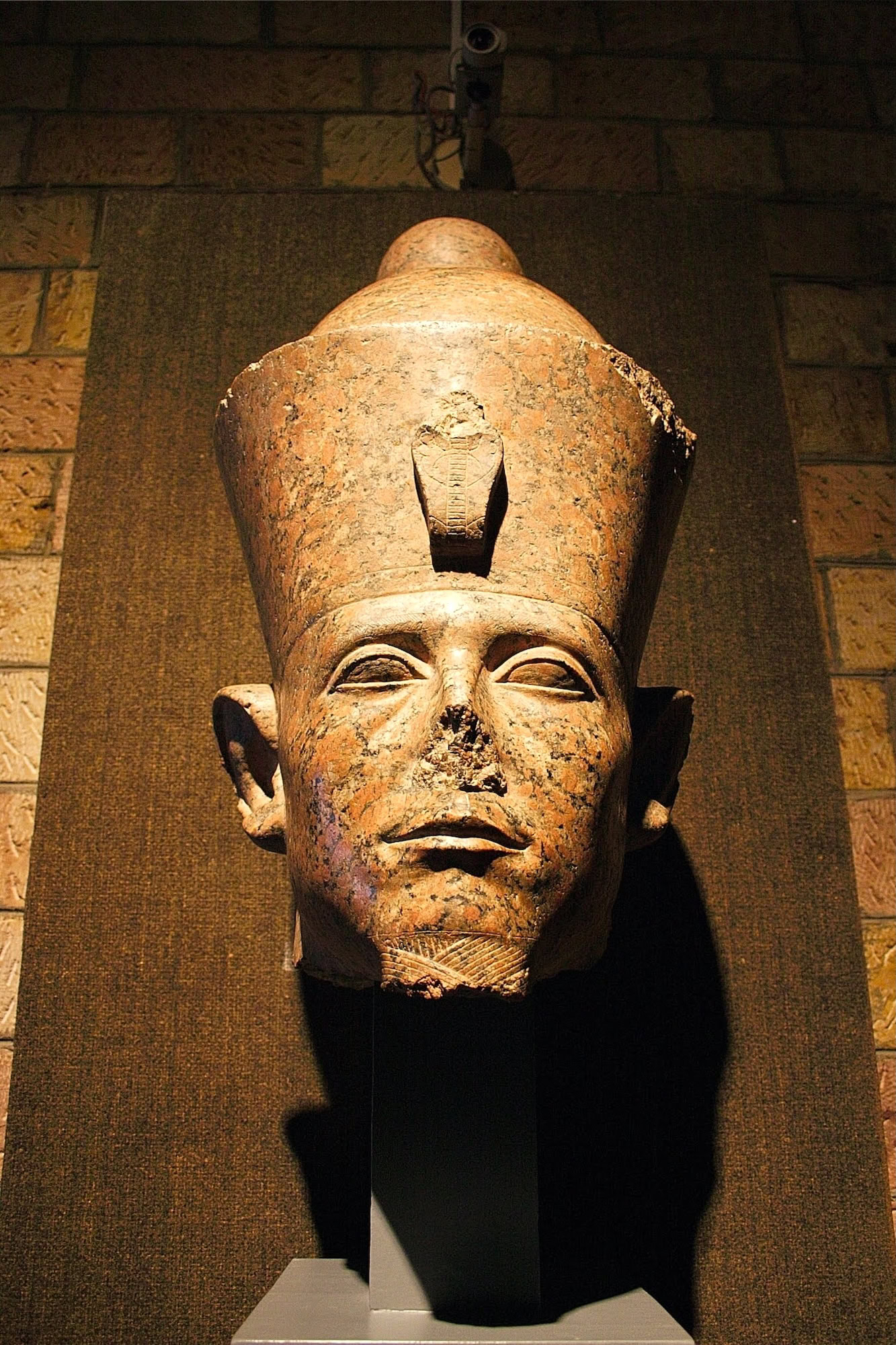 Ancient Egyptian pharaoh statue displayed in museum setting