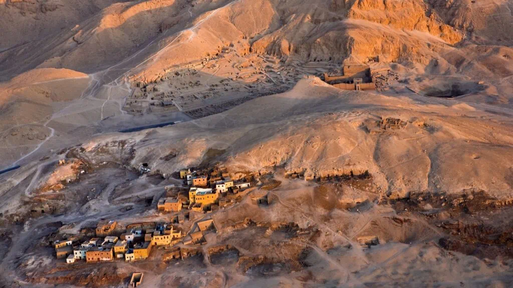 Aerial view of the West Bank landscape showing the ruins of Deir el-Medina and surrounding necropolis areas, Luxor