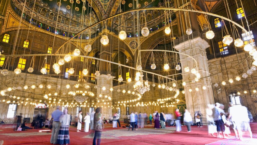 Interior view of hanging lamps suspended from the domed roof inside the Mosque of Muhammad Ali, Cairo