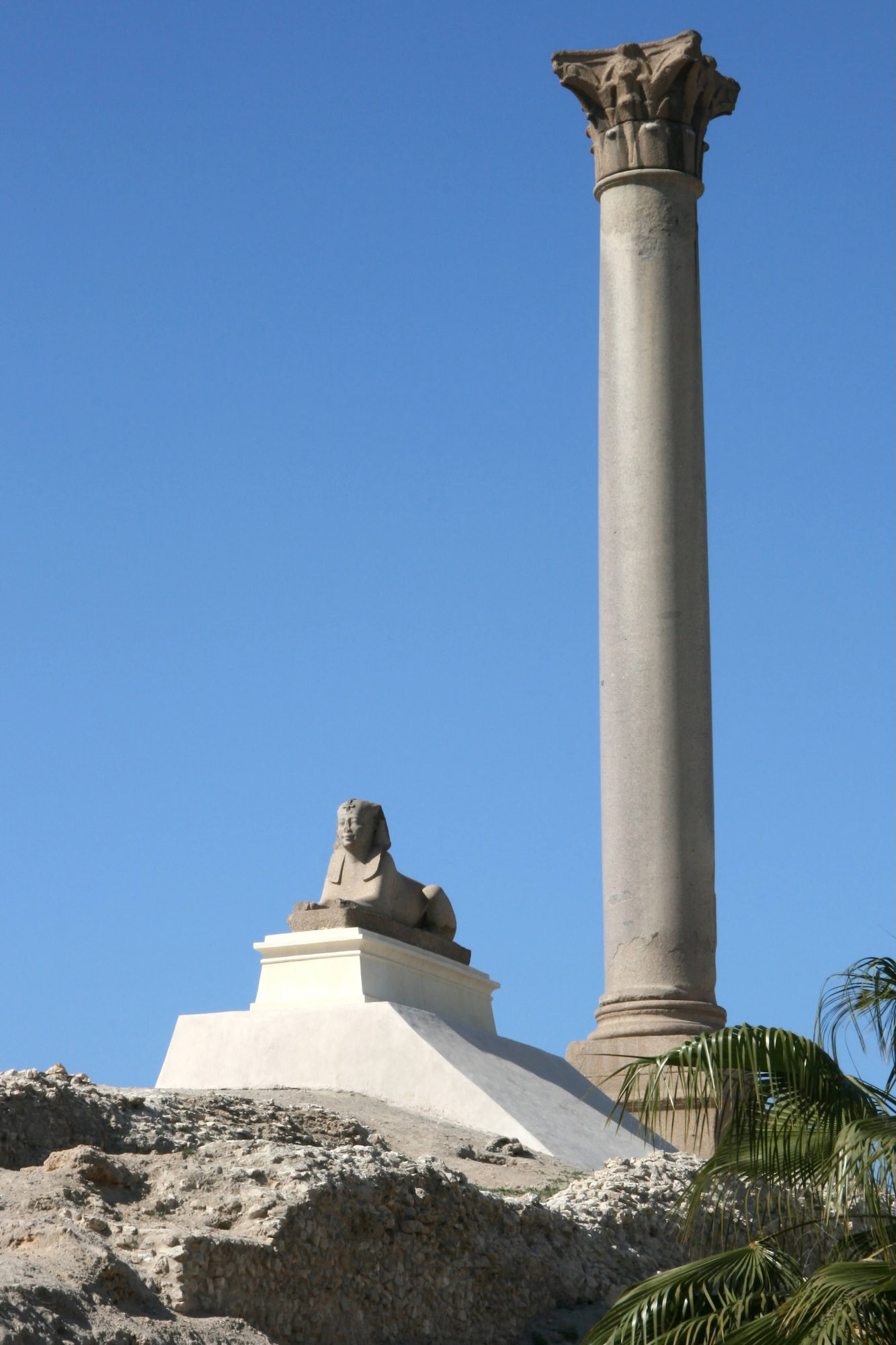 Ancient Roman column with sphinx statue at the Pompey’s Pillar archaeological site, Alexandria