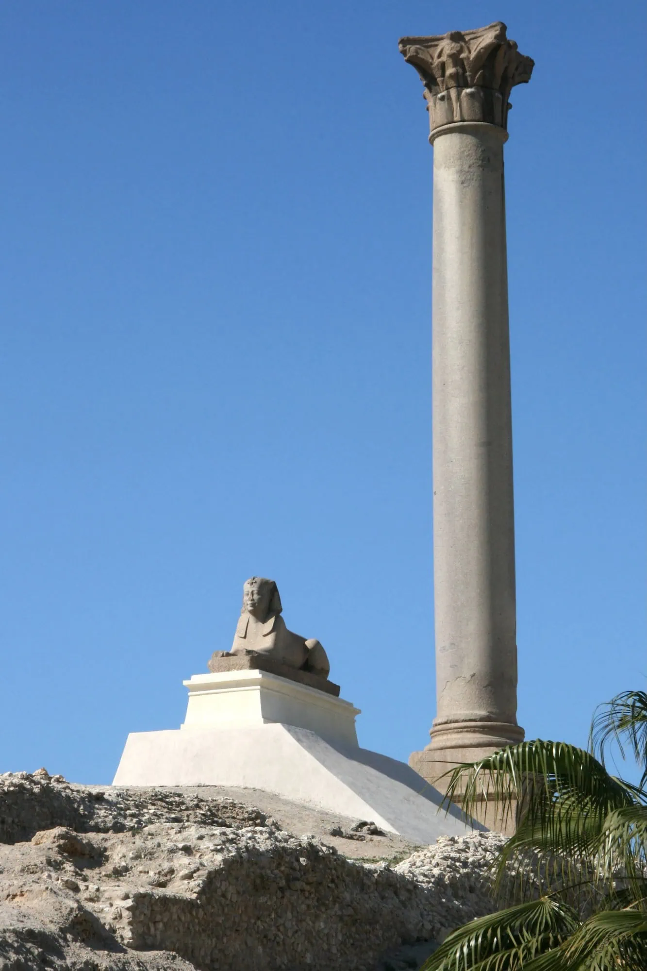 Ancient Roman column with sphinx statue at the Pompey’s Pillar archaeological site, Alexandria