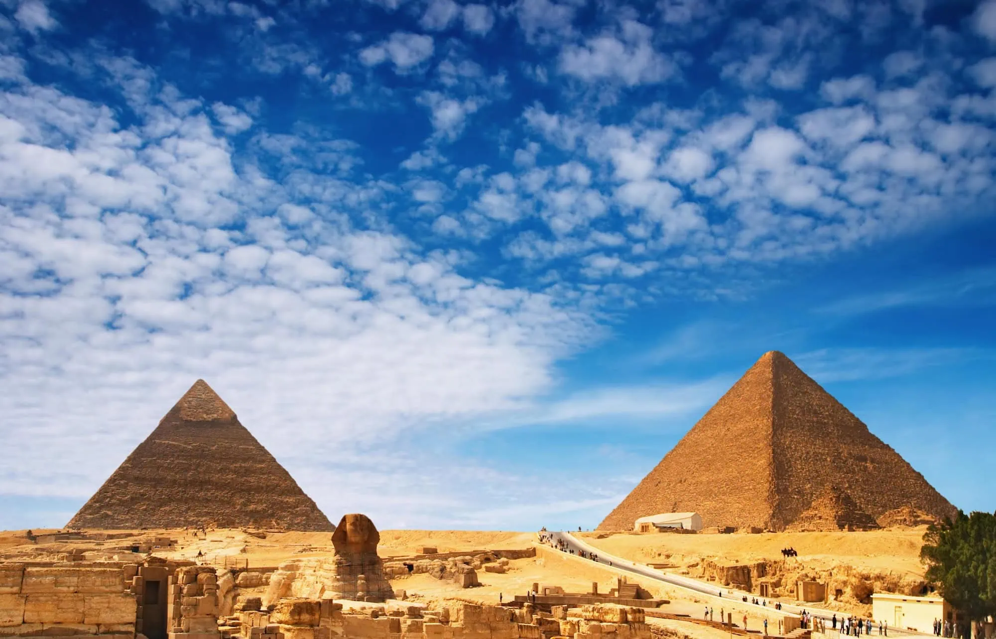 Panoramic view of the Giza pyramid complex showing pyramids and Great Sphinx