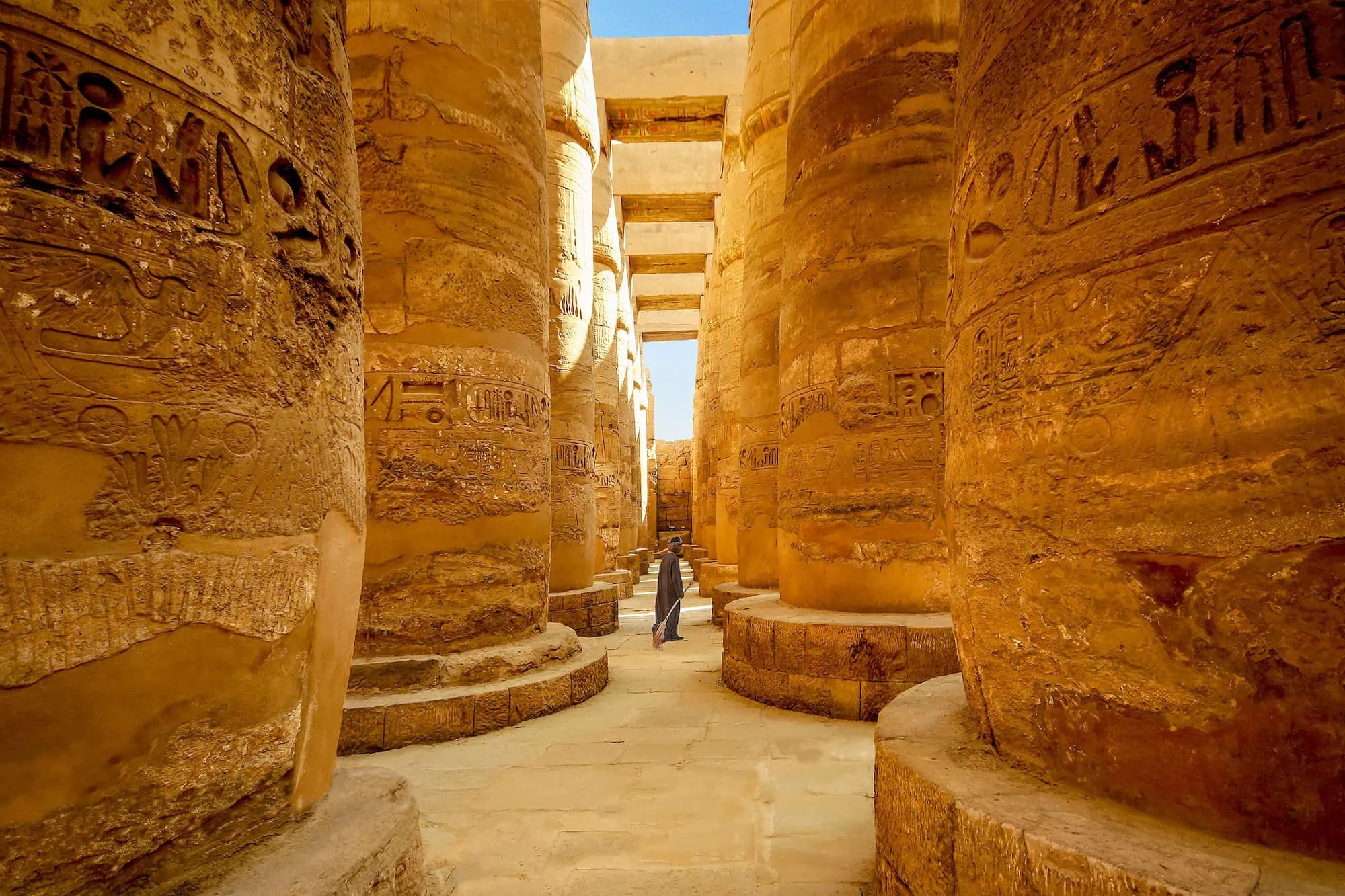 Massive ancient stone columns with hieroglyphics at Karnak Temple Complex