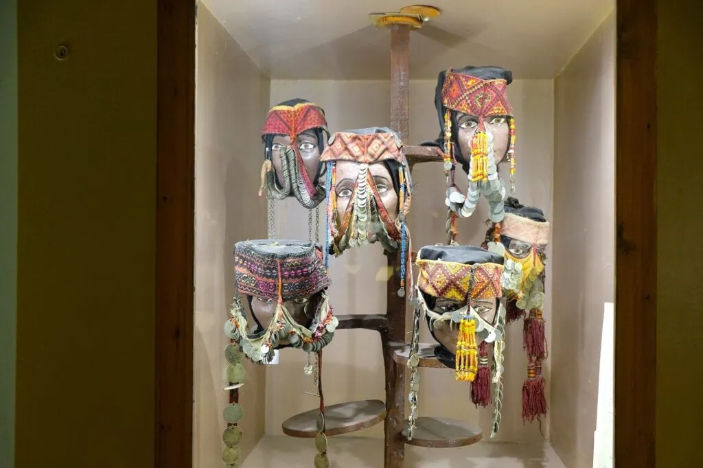 Traditional masks displayed in glass cases at the Jordan Folklore Museum, Amman