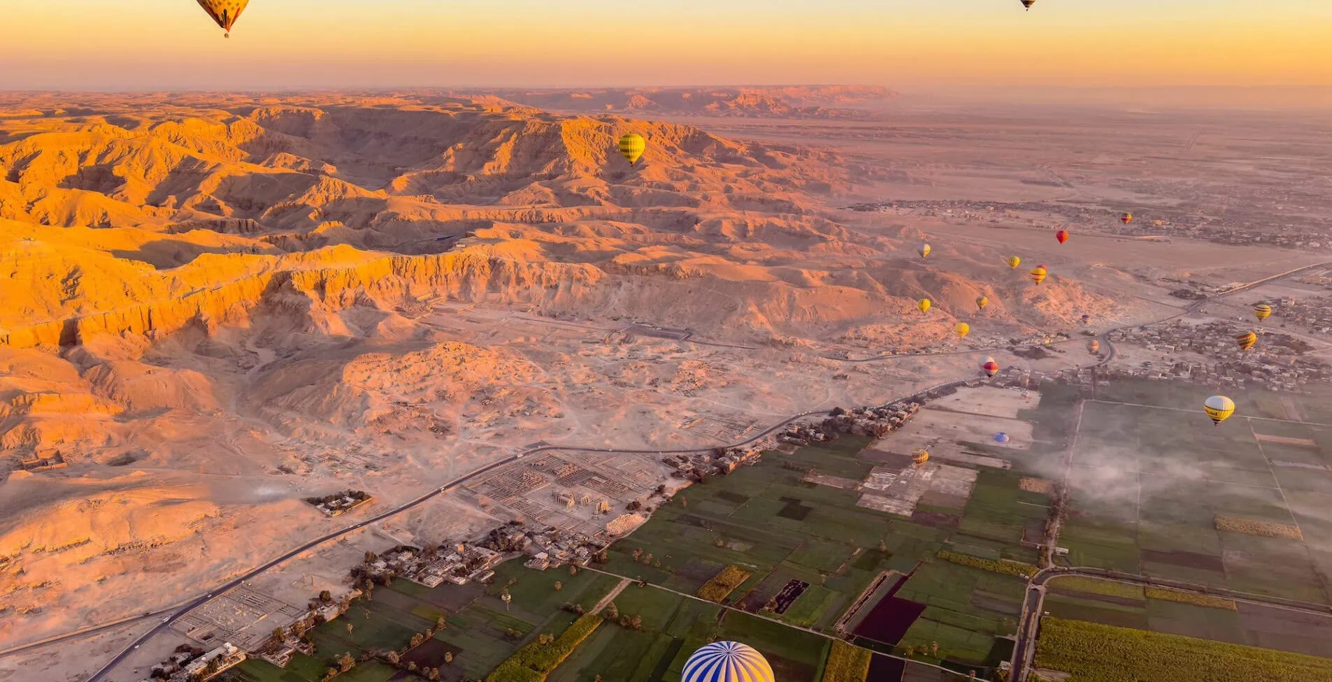 Experience the magic of Luxor from a unique perspective as you fly over the ancient city by hot air balloon. Contrast between the lush Nile Valley and the arid desert 1905x976 crop 49 45