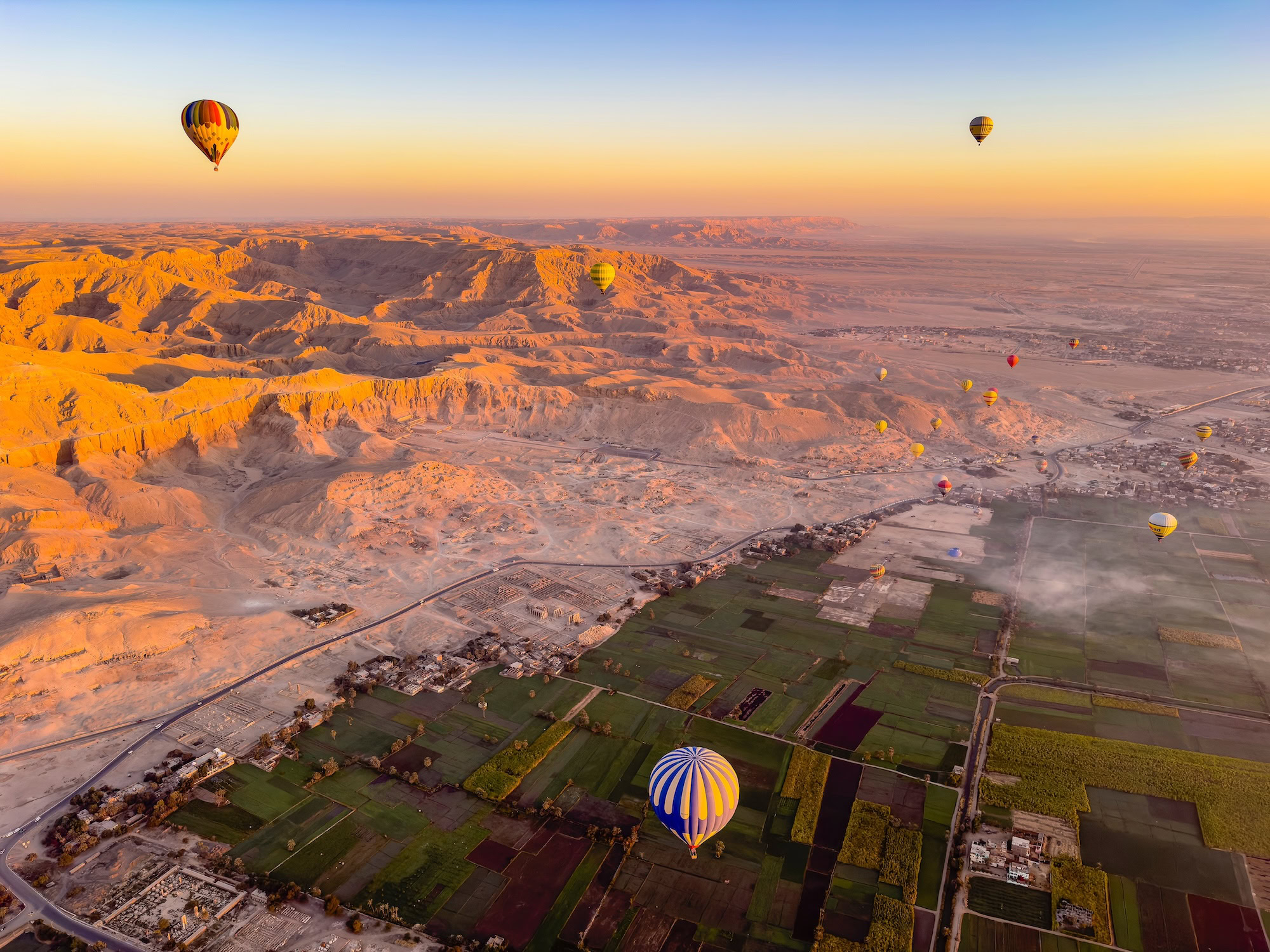 Aerial view of Valley of the Kings with ancient tombs and Nile river valley below