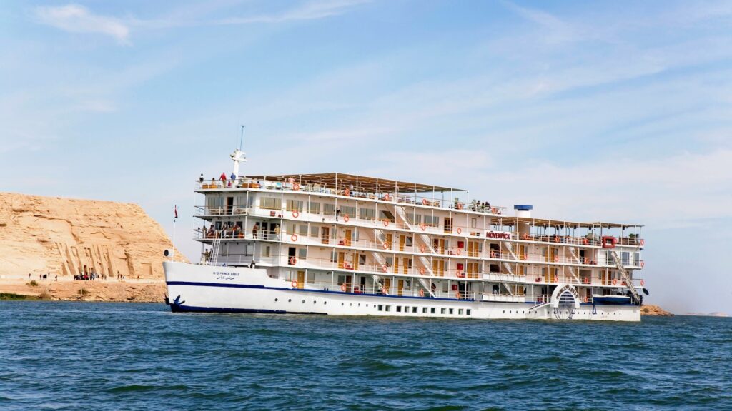 Nile cruise ship sailing by Abu Simbel’s monumental statues