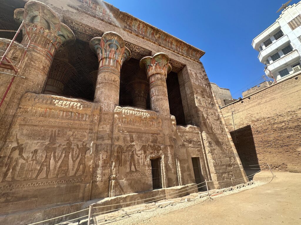 Exterior view of the stone facade and columns of the Temple of Khnum, Esna