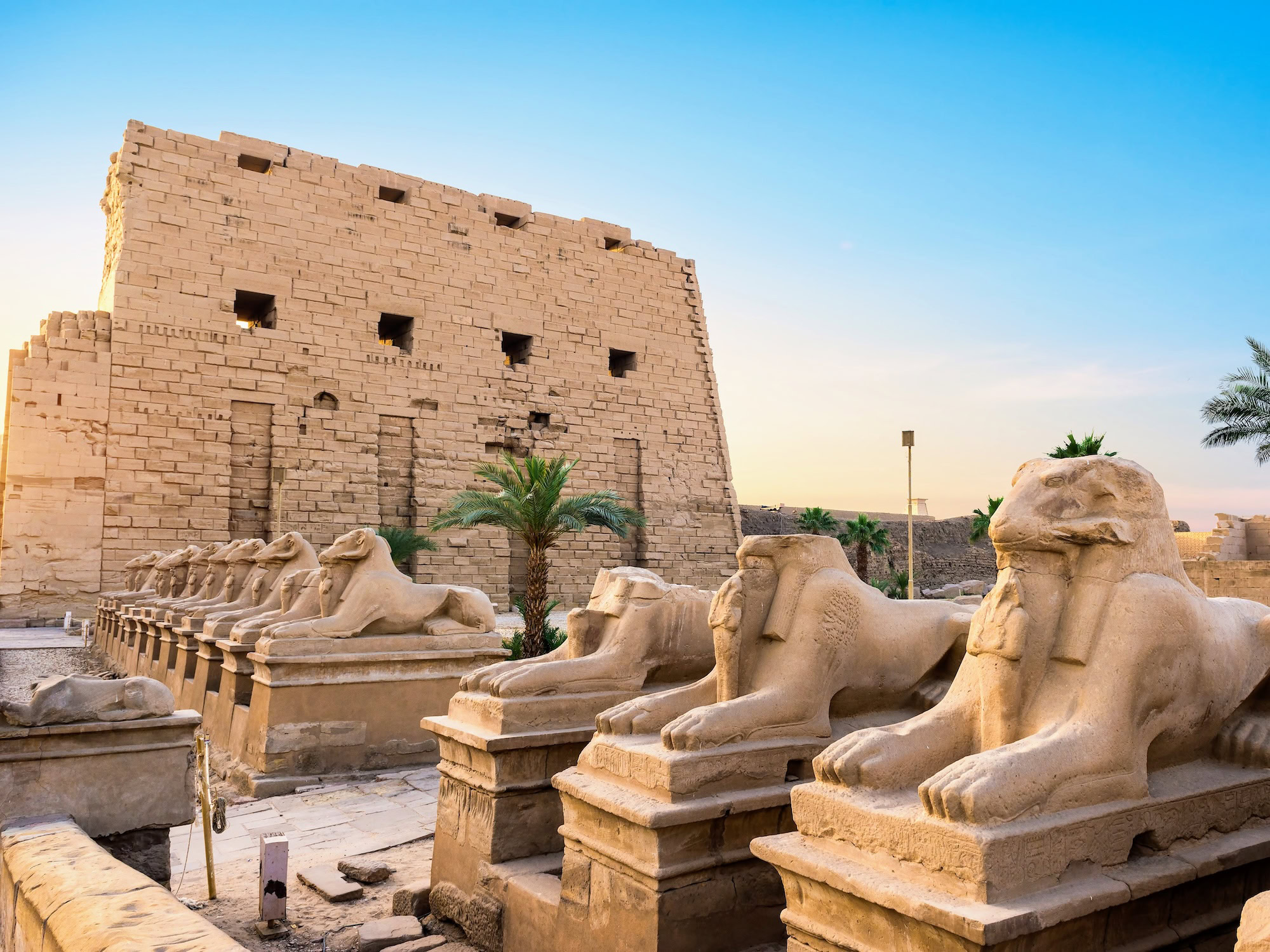 Ancient sphinx statues lining the avenue at Karnak Temple in Luxor, Egypt