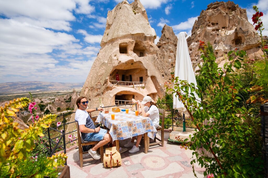 Family of father and teenage daughter having a break at little cafe while exploring Cappadocia in Turkey