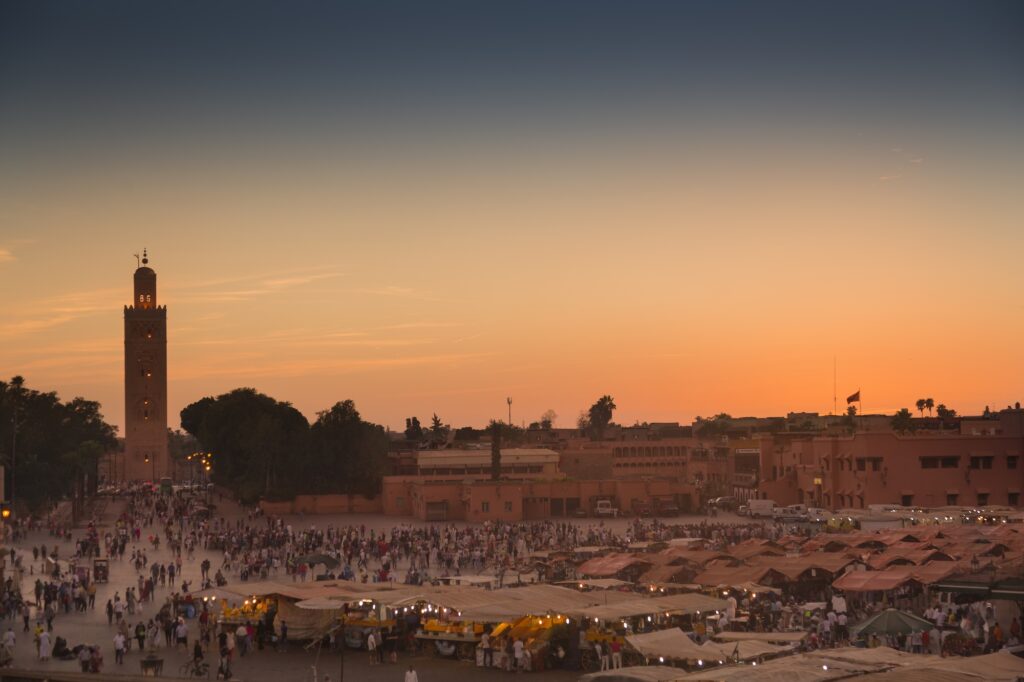 Famous Jemaa el Fna square crowded at dusk