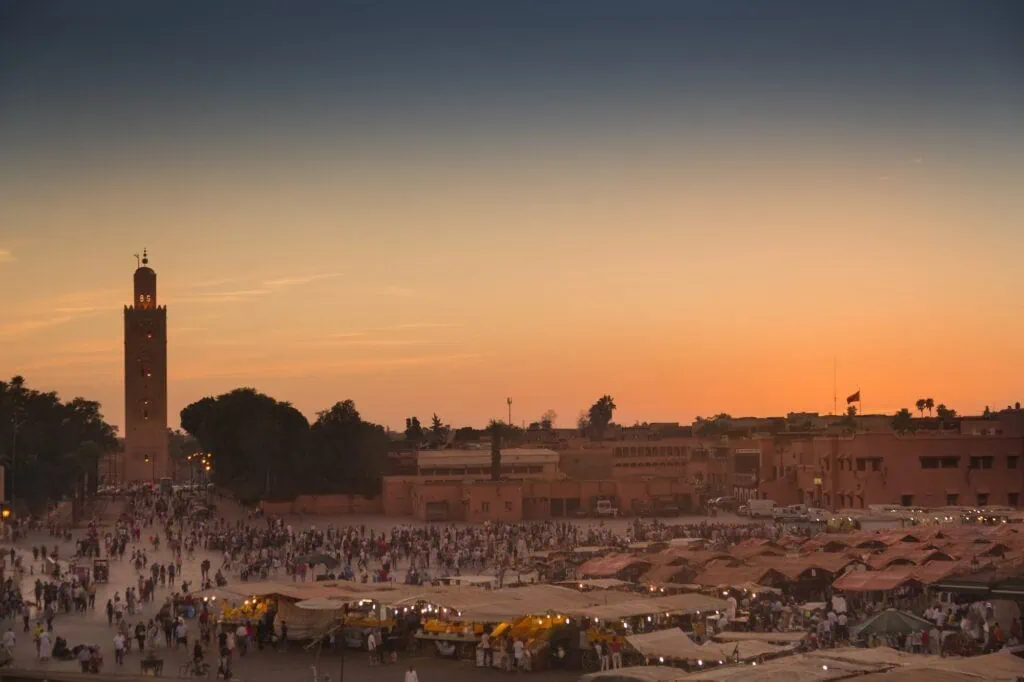 Famous Jemaa el Fna square crowded at dusk