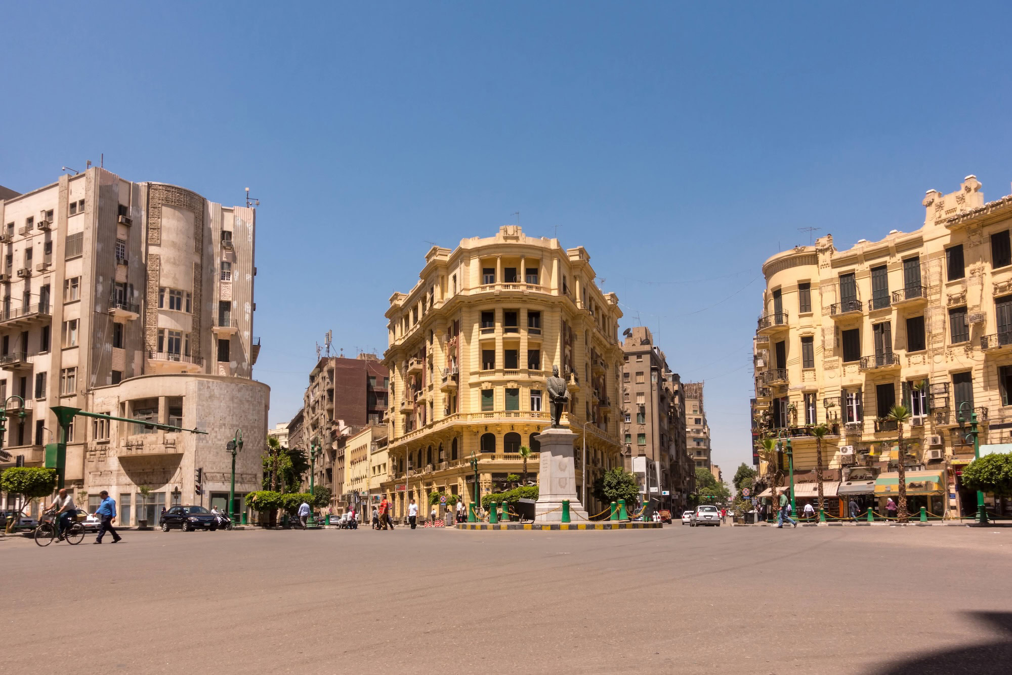 Bustling urban square in Cairo with cars, pedestrians and historic buildings